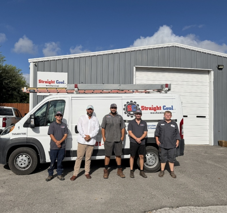 Straight Cool Mechanical technicians standing in front of a service van providing emergency AC repair in San Antonio for commercial buildings